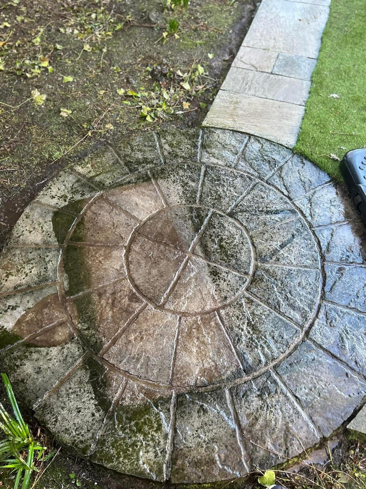 Circular patio feature before pressure washing