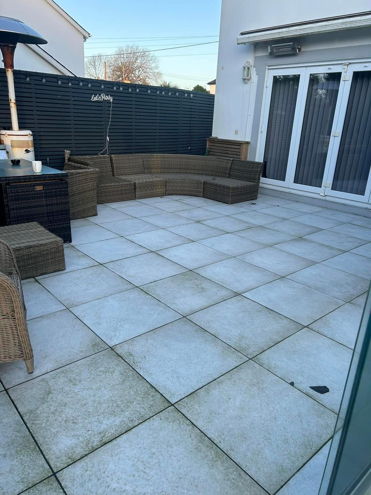 Porcelain patio before cleaning showing surface grime